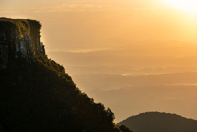 Scenic view of silhouette mountains against sky at sunset