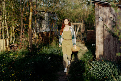 Portrait of young woman walking in forest