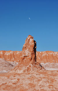 Low angle view of rocky mountains against clear sky