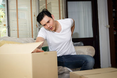 Young man sitting on sofa