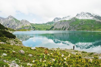 Scenic view of lake and mountains against sky