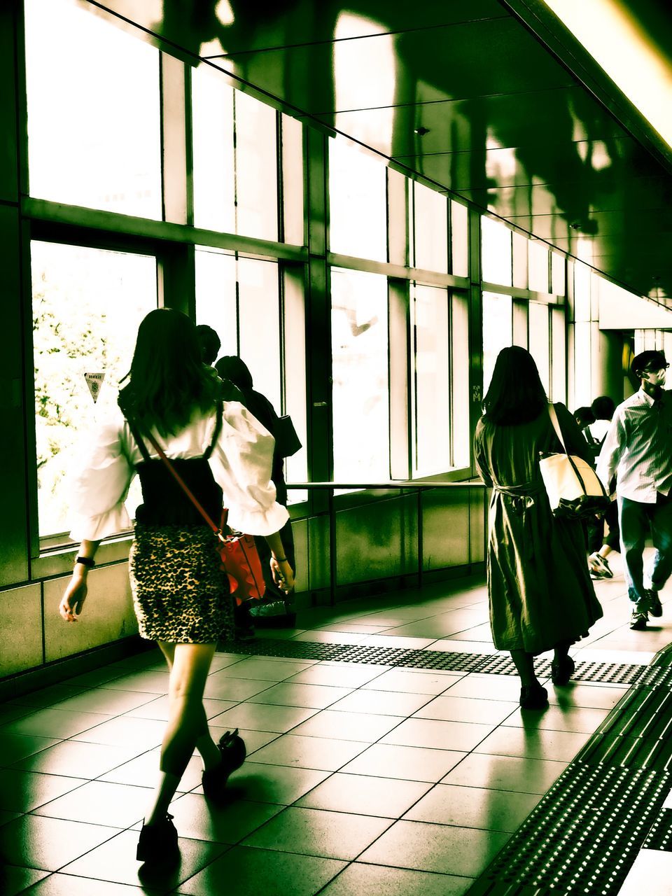 full length, walking, real people, indoors, rear view, journey, transportation, standing, day, women, luggage, architecture, one person, people