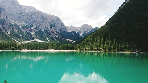 Scenic view of lake by mountains against sky