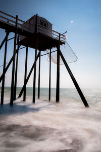 Lifeguard hut on sea against sky