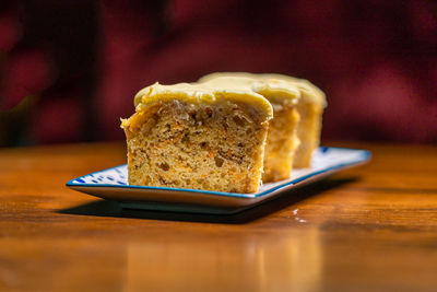 Slices of carrot cake in a plate on a wooden a table