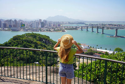 Traveler woman enjoying vitoria cityscape with terceira ponte bridge vitoria, espirito santo, brazil