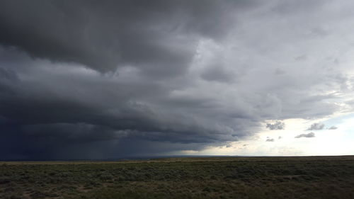 Scenic view of landscape against cloudy sky