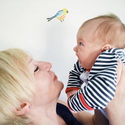 Close-up of mother holding baby at home