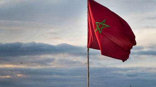 Low angle view of flag against sky