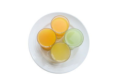 High angle view of drink in plate against white background