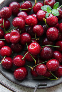 Fresh red cherries fruit on a concrete background