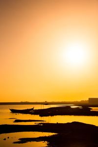 Scenic view of sea against orange sky