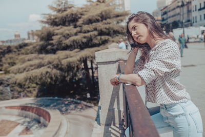 Young woman smiling while standing outdoors