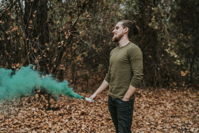 Full length of young man standing in forest