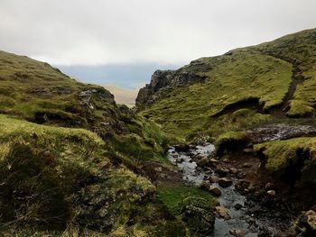 Stream and mountains against sky