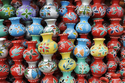 Stack of colorful pots for sale