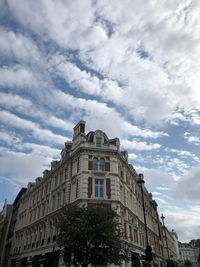 Low angle view of building against cloudy sky