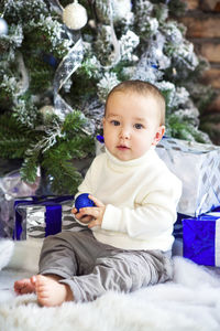 Full length of cute baby boy sitting in park