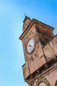 Low angle view of clock tower against sky