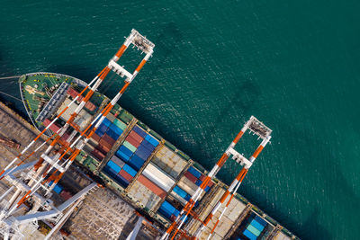 High angle view of commercial dock and containers ship with crane loading unloading in thailand 
