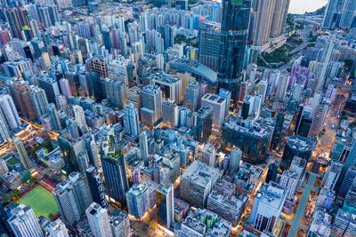 Aerial view of buildings in city against sky at dusk