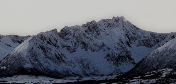 Scenic view of snowcapped mountains against clear sky