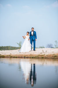 Young couple kissing against clear sky