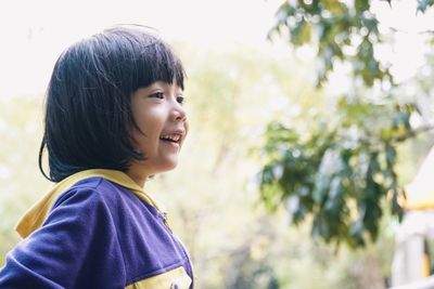 Close-up of smiling girl looking away