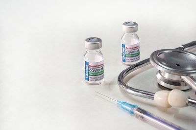 High angle view of bottles vaccine on white table