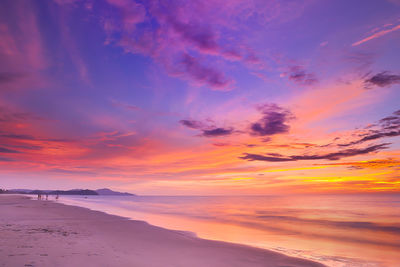 Scenic view of sea against dramatic sky during sunset