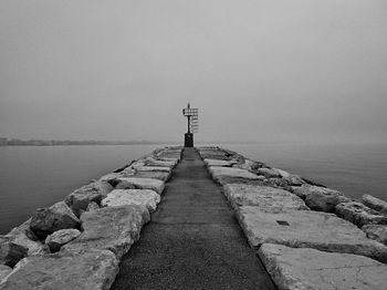 Pier over sea against sky