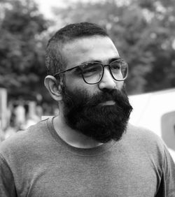 Bearded man wearing eyeglasses looking away outdoors