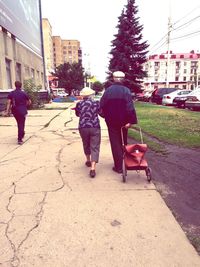 Rear view of woman walking on street