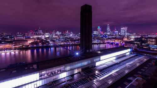 High angle view of illuminated cityscape against sky at night