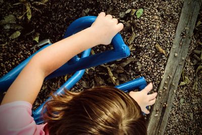 High angle view of playful child on play equipment at park