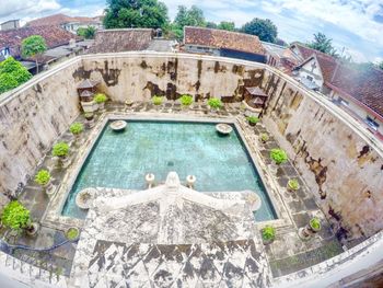 High angle view of swimming pool in city against sky