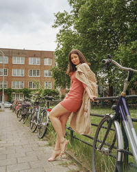 Portrait of young woman standing on street