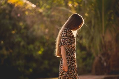 Close-up of woman standing against blurred background