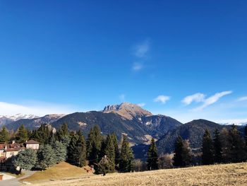 Scenic view of mountains against blue sky