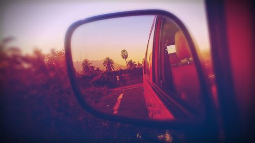 Reflection of car on side-view mirror