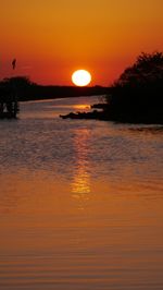 Scenic view of sea against orange sky