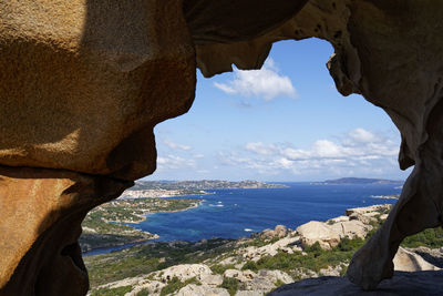 Rock formations by sea against sky