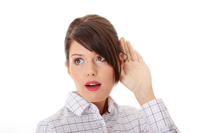 Portrait of young woman against white background