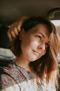 Close-up portrait of a smiling young woman