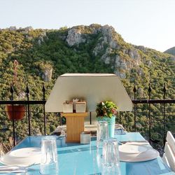 Chairs and tables at restaurant against clear sky