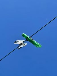 Low angle view of cable against clear blue sky