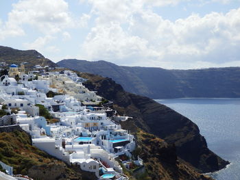 Scenic view of santorini by aegean sea against mountains