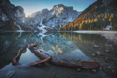 Scenic view of lake by mountains against sky