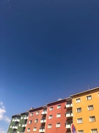 Low angle view of buildings against blue sky