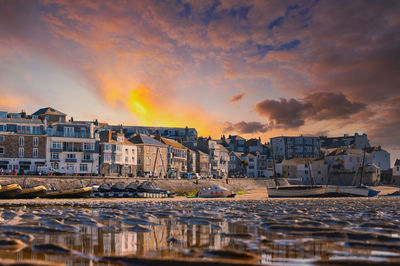 Buildings against sky during sunset